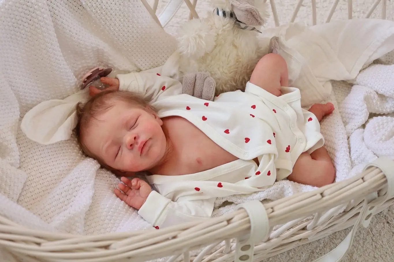 Luxury collector reborn baby doll in an elegant cream and gold dress