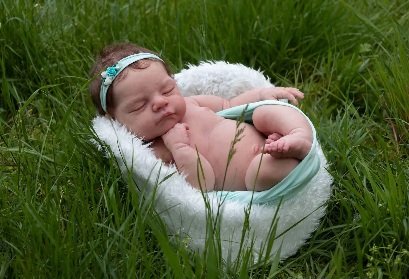 Premium reborn baby doll in an elegant pink lace outfit